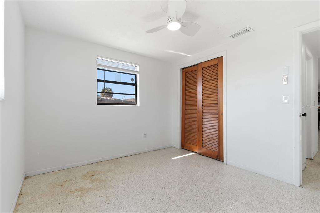 3922 Darlington Road Holiday, FL 34691 - Photo 14 of 30 an empty room with windows and fan