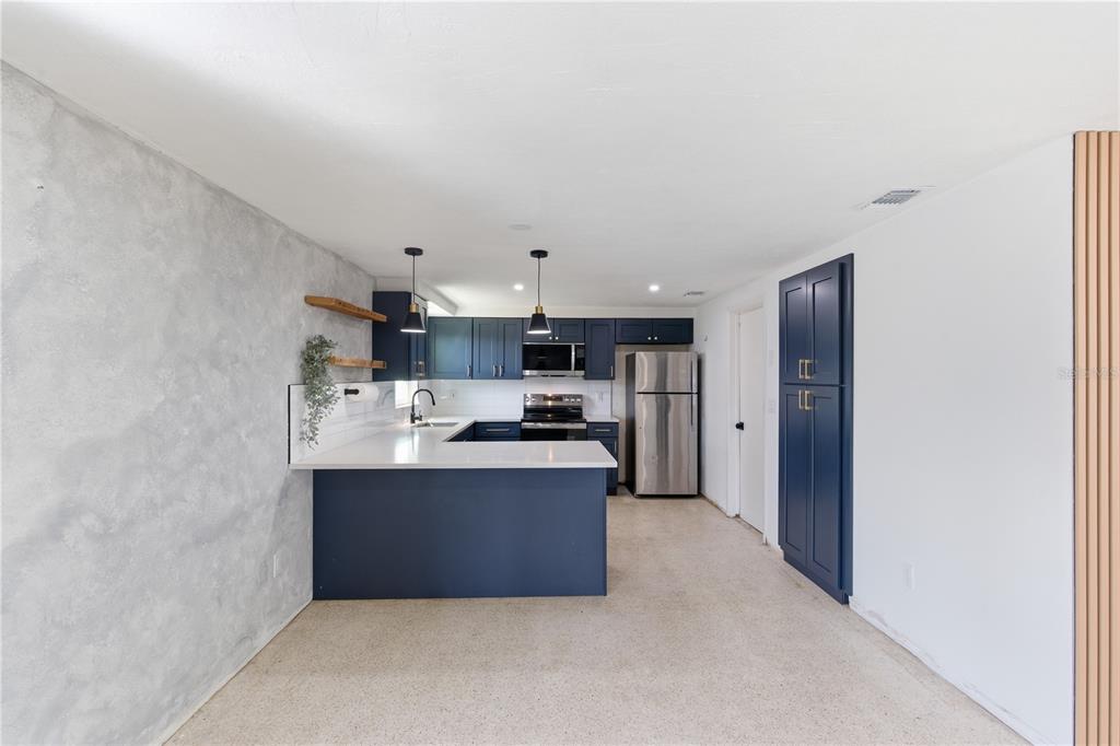 3922 Darlington Road Holiday, FL 34691 - Photo 16 of 30 a kitchen with stainless steel appliances a sink stove and refrigerator