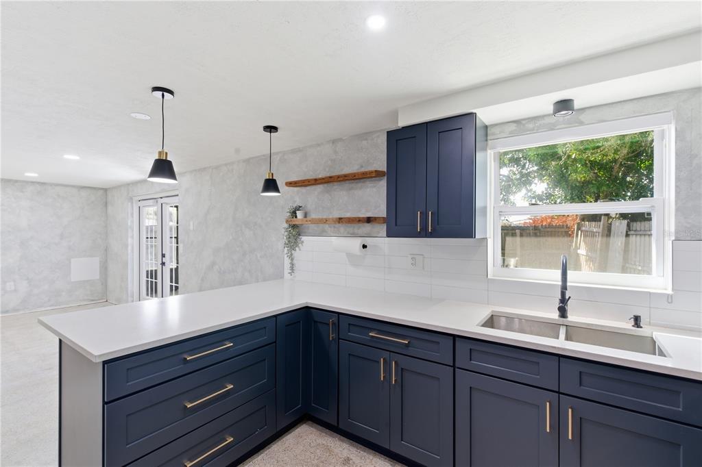 3922 Darlington Road Holiday, FL 34691 - Photo 20 of 30 a kitchen with a sink and wooden cabinets