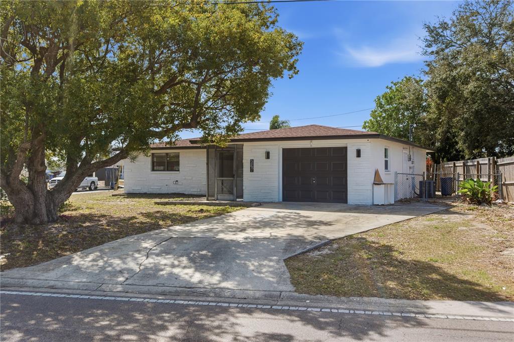 3922 Darlington Road Holiday, FL 34691 - Photo 26 of 30 a front view of a house with a yard and garage