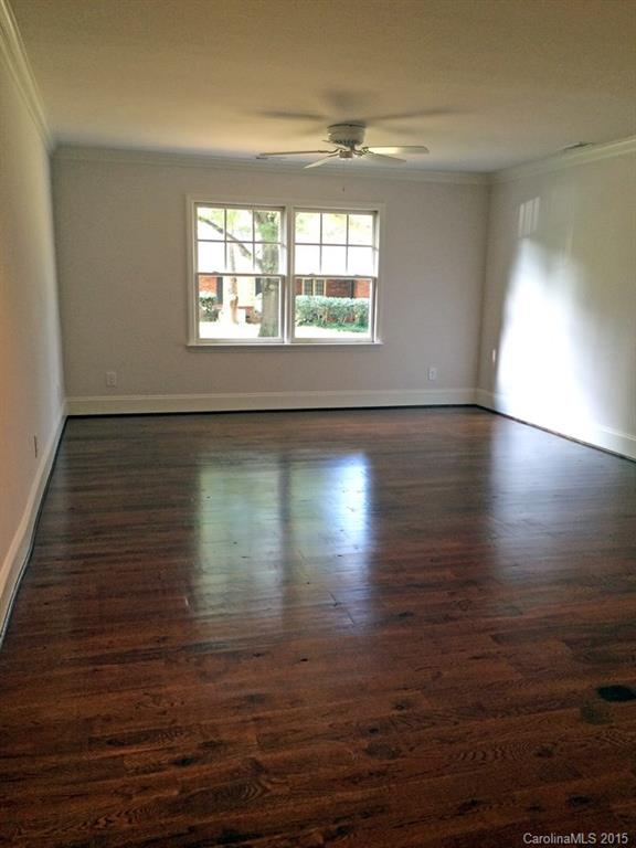 3003 Clarendon Road, Unit A Charlotte, NC 28211 - Photo 12 of 13 an empty room with wooden floor and windows