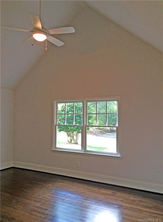 3003 Clarendon Road, Unit A Charlotte, NC 28211 - Photo 9 of 13 a view of an empty room with wooden floor and a window