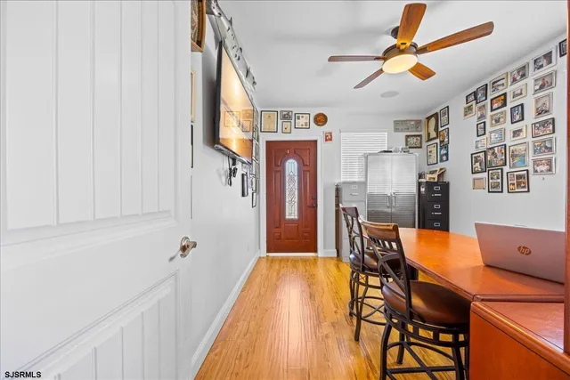 a view of a dining room with furniture and wooden floor