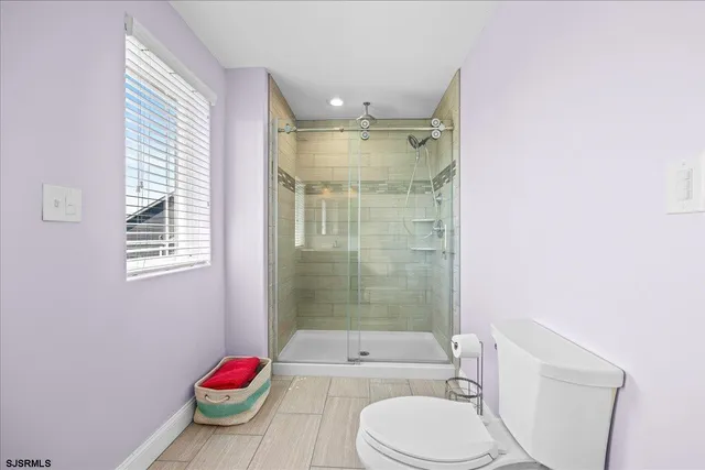 a bathroom with a bath tub sink mirror vanity and toilet