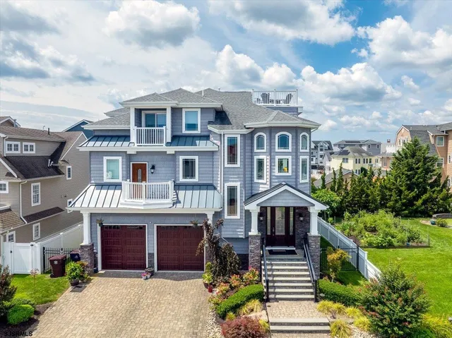 an aerial view of a house with a big yard and large trees