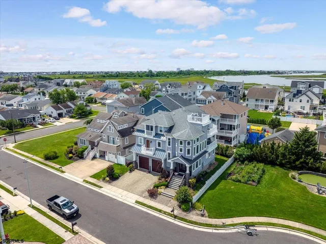 an aerial view of houses with an outdoor space and seating