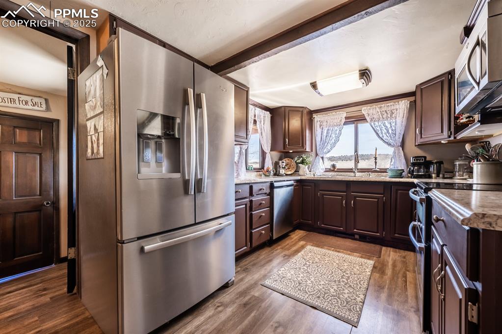 8419 3 R Road Beulah, CO 81023 - Photo 11 of 35 a kitchen with stainless steel appliances granite countertop a refrigerator a sink a stove and white cabinets