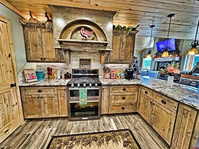 a kitchen with stainless steel appliances granite countertop a stove and cabinets