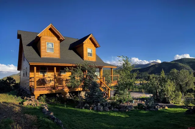 a front view of house and yard with green space