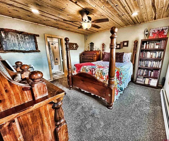 a bedroom with furniture and a chandelier