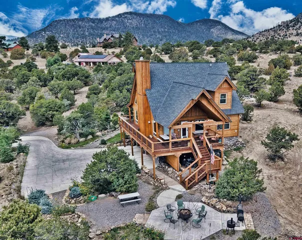 an aerial view of a house with a big yard