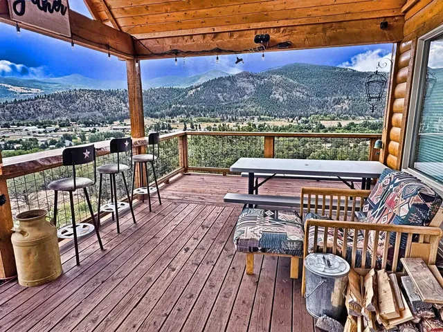 a view of a chairs and table in the balcony