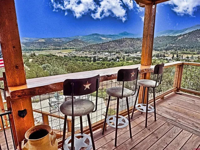 a view of a balcony with table and chairs