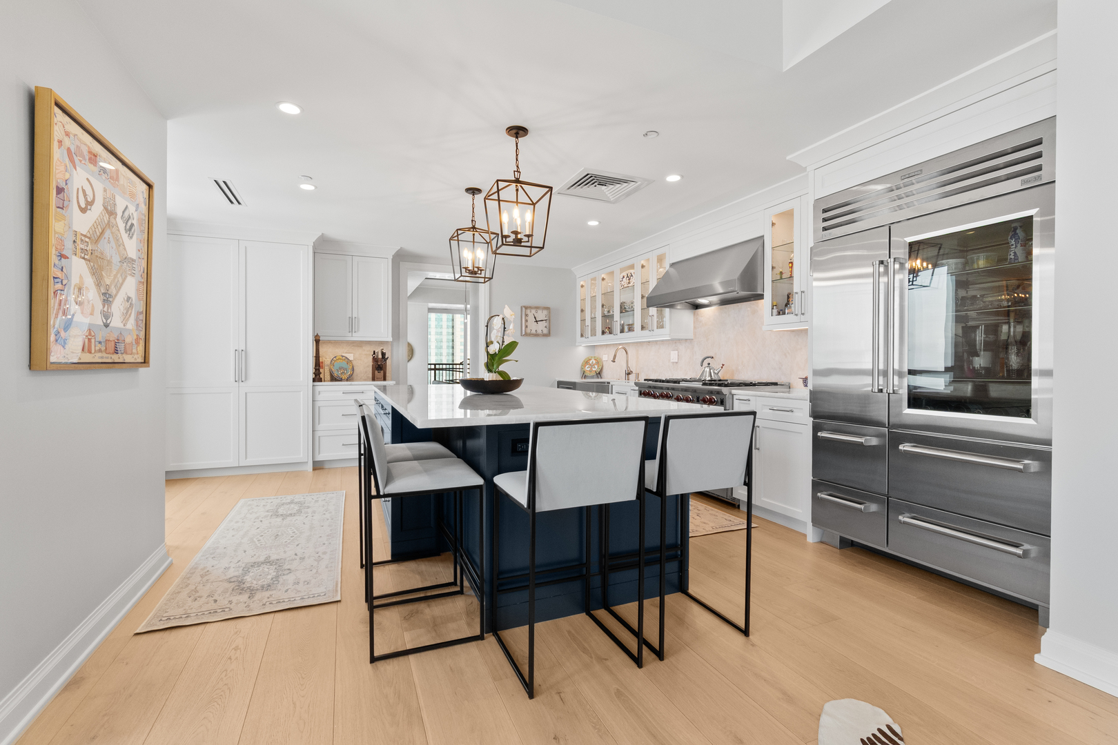 11 East Walton Street, Unit 4802 Chicago, IL 60611 - Photo 18 of 47 a kitchen with a dining table chairs and cabinets