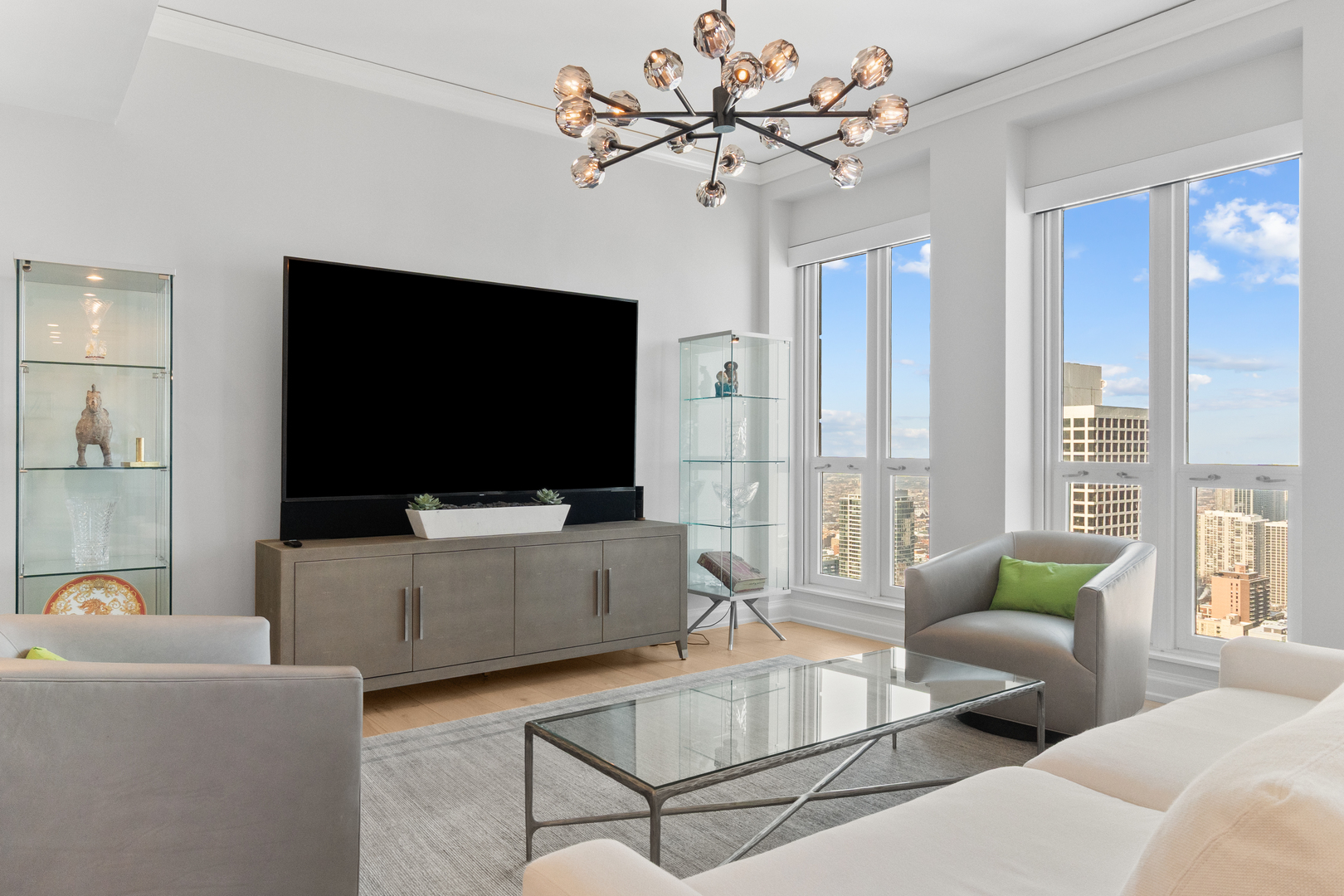 11 East Walton Street, Unit 4802 Chicago, IL 60611 - Photo 23 of 47 a living room with furniture and a flat screen tv