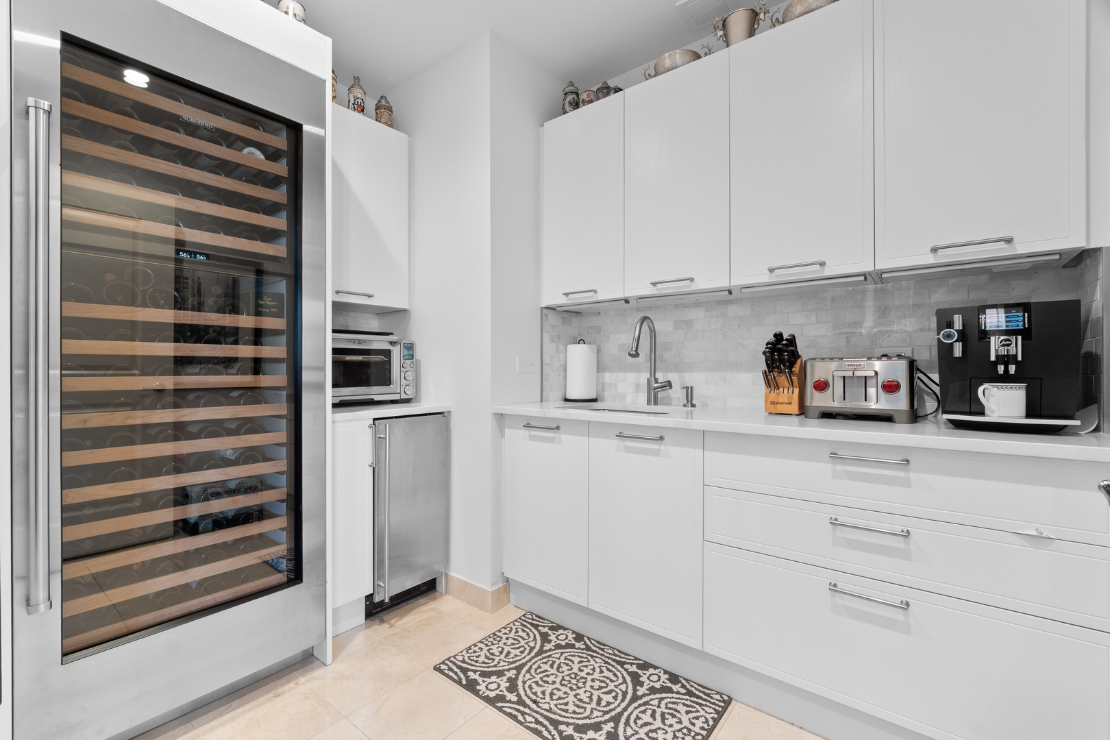 11 East Walton Street, Unit 4802 Chicago, IL 60611 - Photo 24 of 47 a kitchen with stainless steel appliances a refrigerator and cabinets