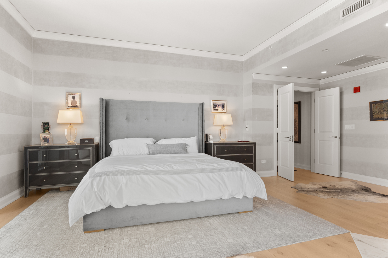 11 East Walton Street, Unit 4802 Chicago, IL 60611 - Photo 28 of 47 a spacious bedroom with a bed and a dresser