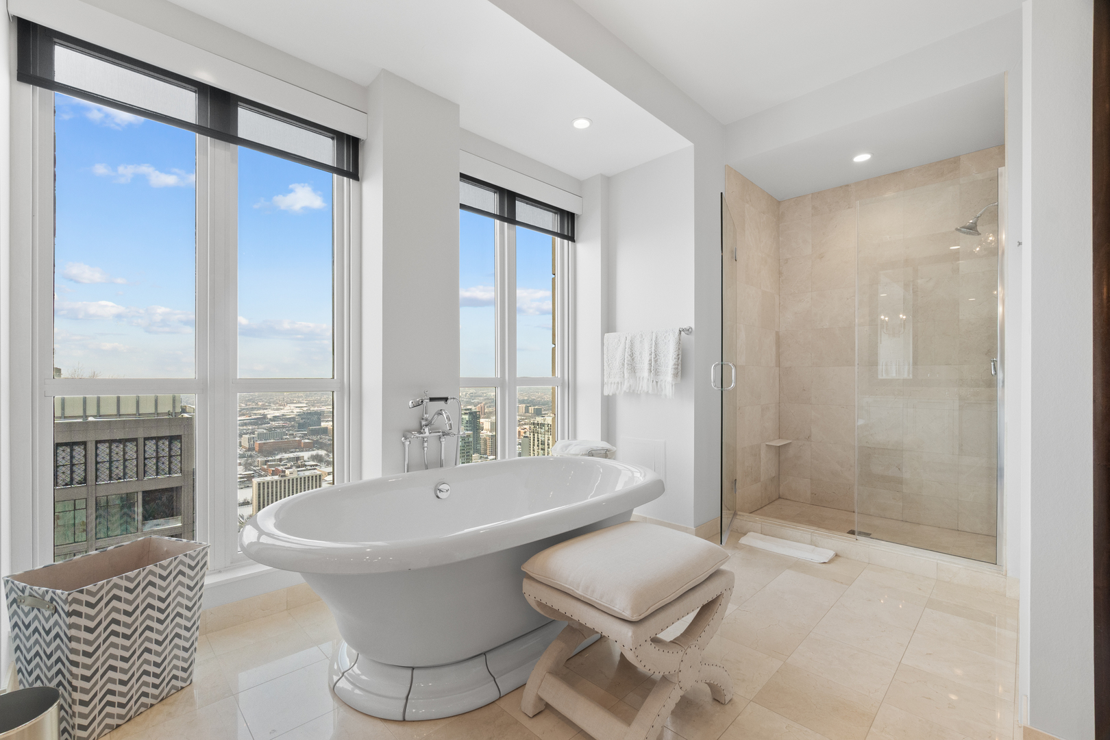 11 East Walton Street, Unit 4802 Chicago, IL 60611 - Photo 31 of 47 a spacious bathroom with a bathtub and a sink