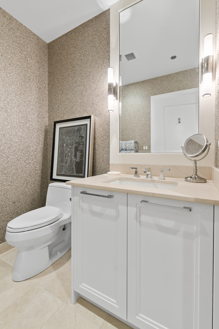 11 East Walton Street, Unit 4802 Chicago, IL 60611 - Photo 44 of 47 a bathroom with a toilet a sink a vanity and mirror