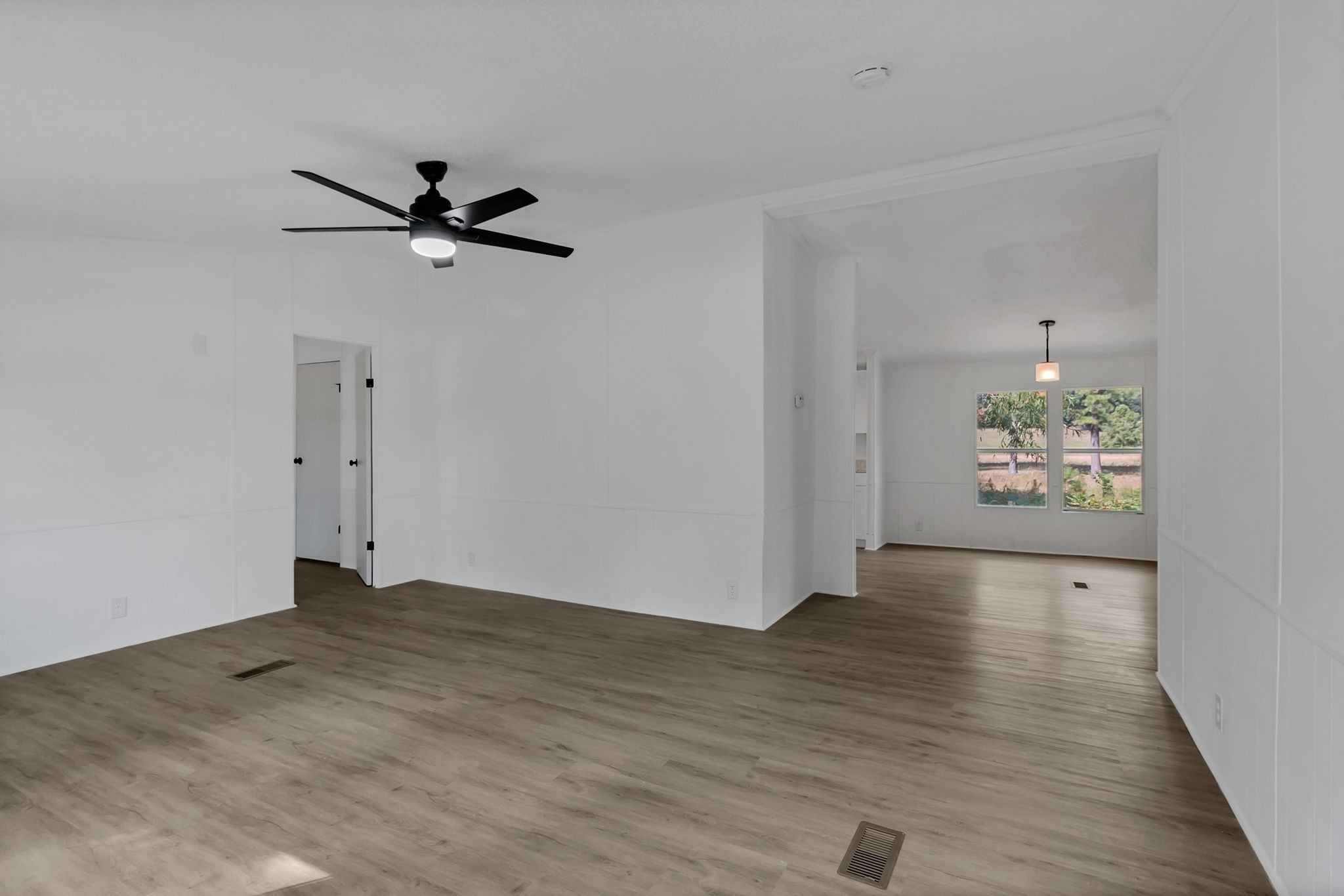 326 Highway 232 Dover, TN 37058 - Photo 11 of 38 an empty room with wooden floor chandelier fan and windows