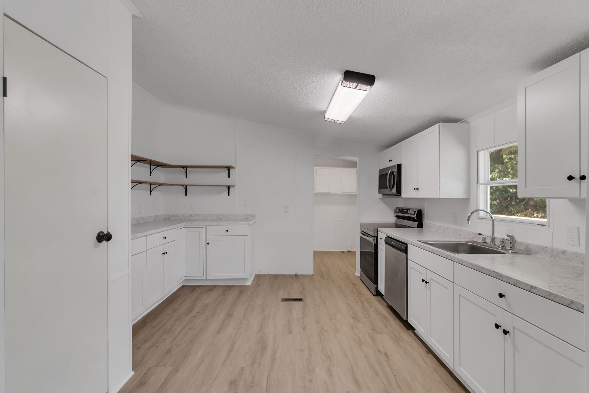 326 Highway 232 Dover, TN 37058 - Photo 14 of 38 a kitchen with cabinets a sink and appliances
