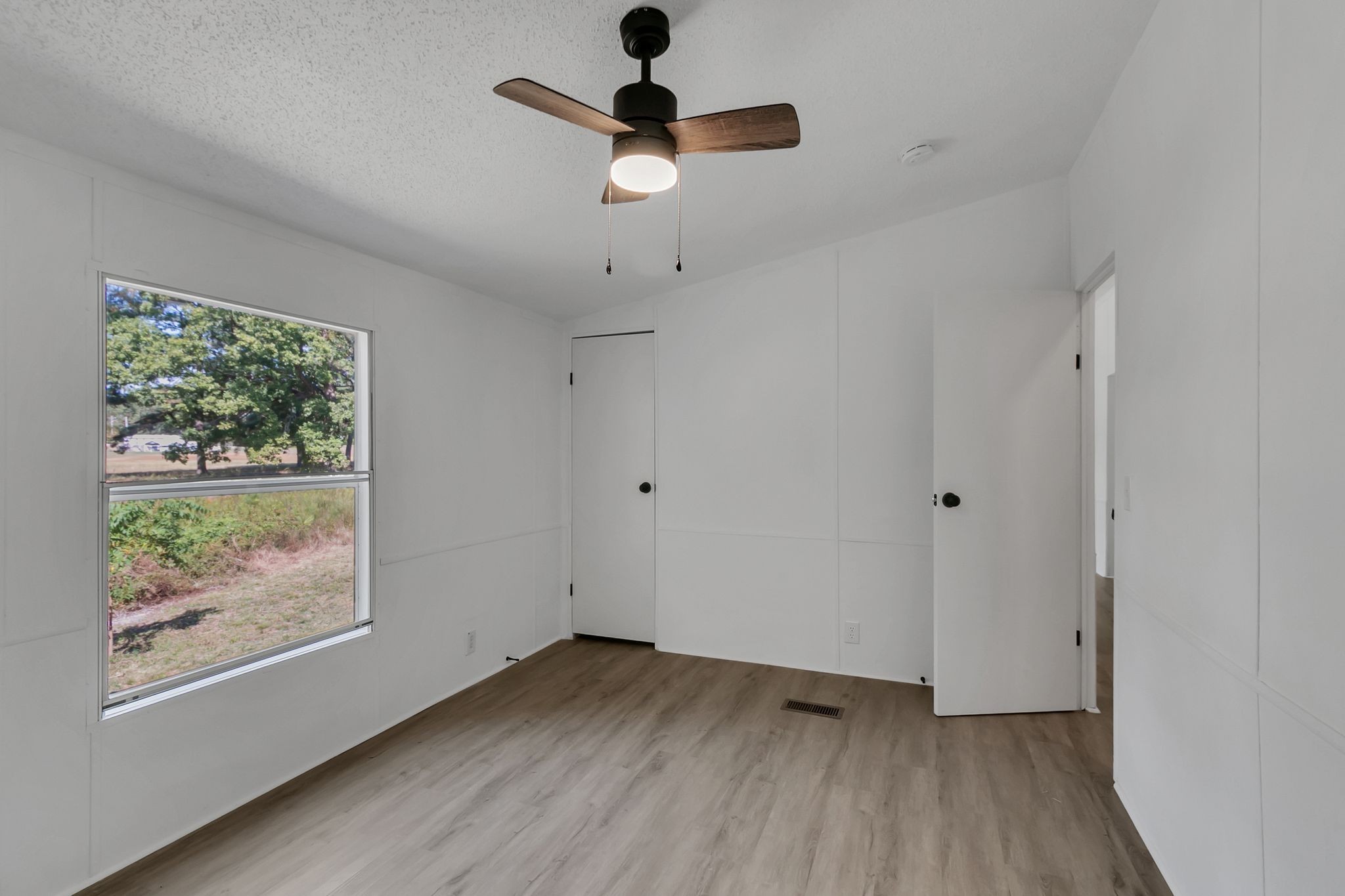 326 Highway 232 Dover, TN 37058 - Photo 25 of 38 a view of an empty room with wooden floor and a window