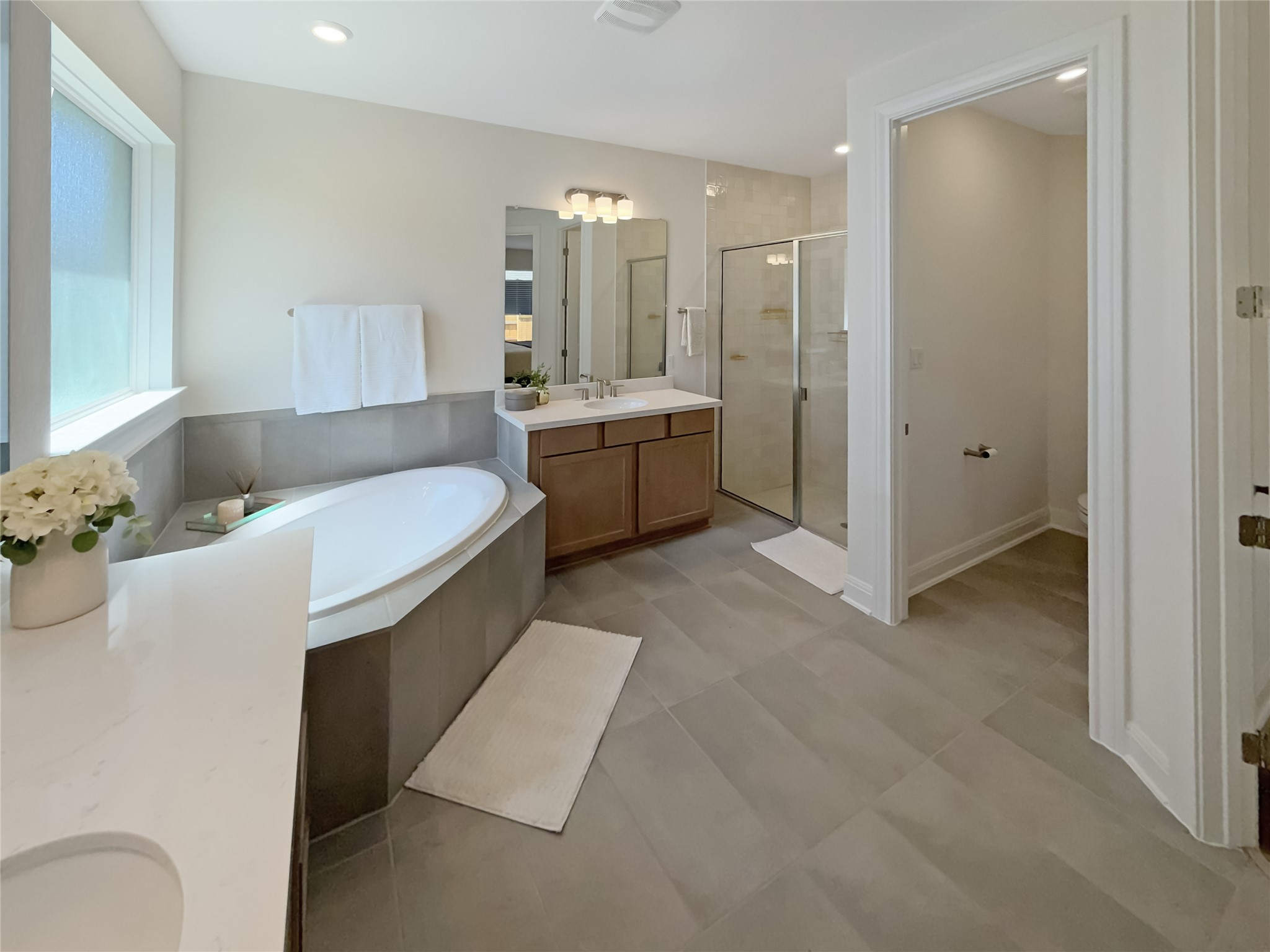 693 Jackson River Loop Kyle, TX 78640 - Photo 16 of 40 a bathroom with a double vanity sink mirror and bathtub