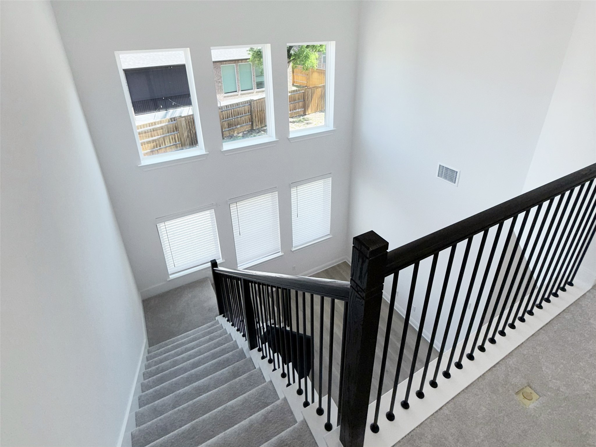 693 Jackson River Loop Kyle, TX 78640 - Photo 19 of 40 a view of staircase with railing and white walls
