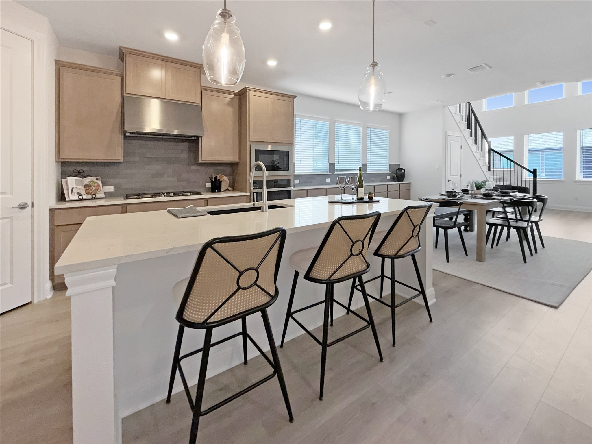 693 Jackson River Loop Kyle, TX 78640 - Photo 7 of 40 a kitchen with stainless steel appliances kitchen island granite countertop a table chairs sink and cabinets