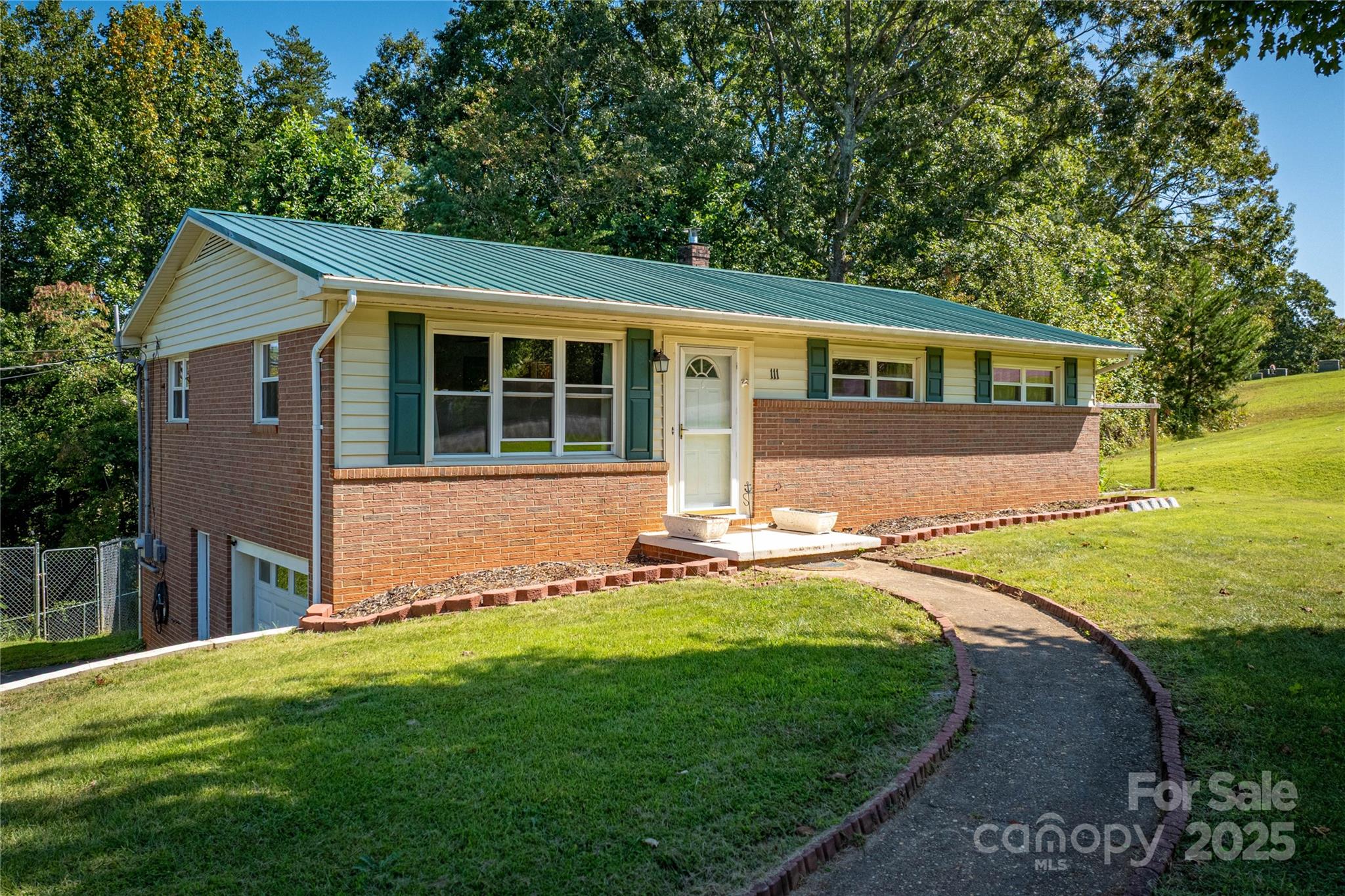 a view of a house with a yard and sitting area