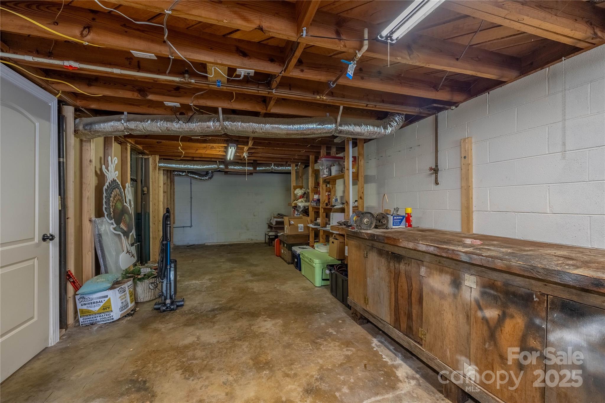 111 Baxter Street Morganton, NC 28655 - Photo 15 of 26 a view of a storage room with wooden shelves