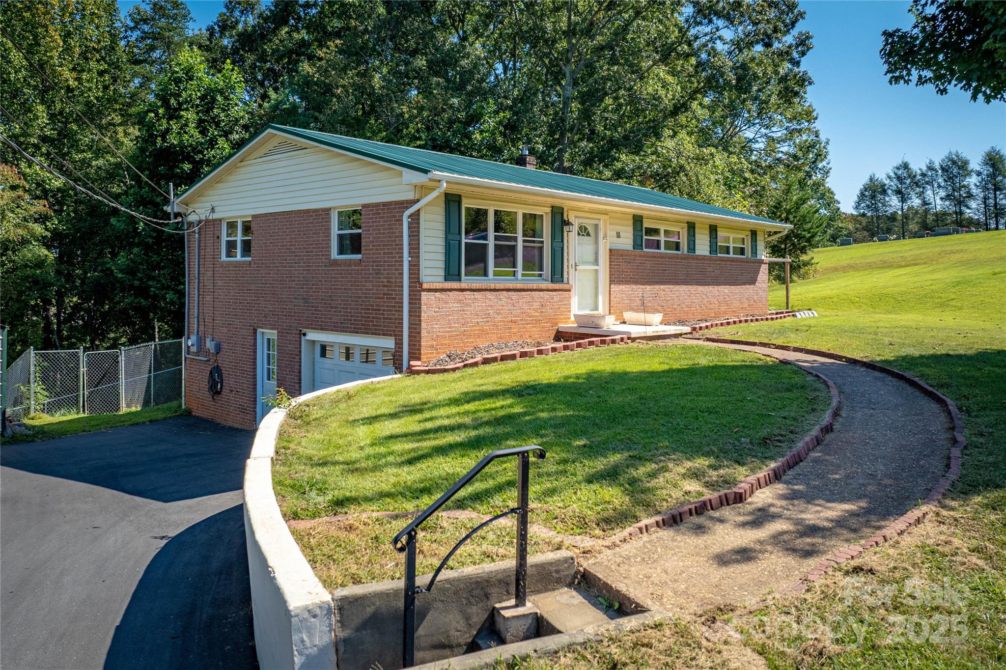 111 Baxter Street Morganton, NC 28655 - Photo 18 of 26 a front view of a house with a yard table and chairs