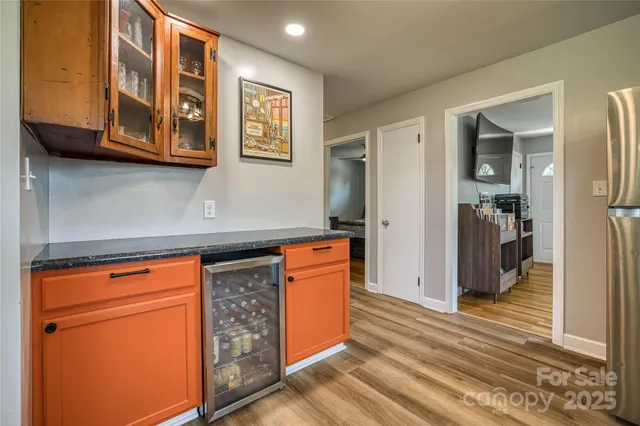 a kitchen with stainless steel appliances granite countertop cabinets and wooden floor
