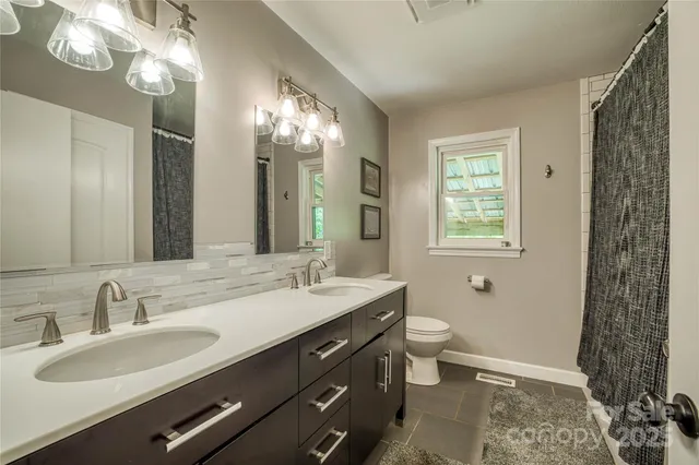 a bathroom with a double vanity sink and a mirror