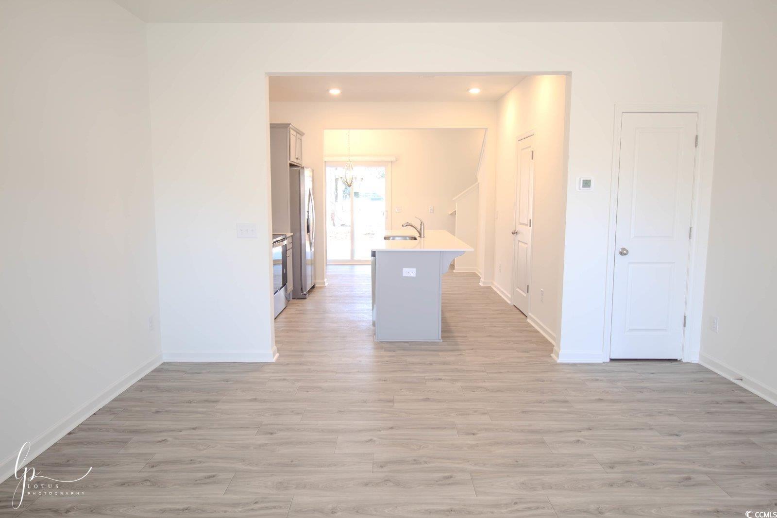 172 Crescent Way Little River, SC 29566 - Photo 4 of 18 Kitchen with light wood-style flooring, baseboards, a sink, and recessed lighting