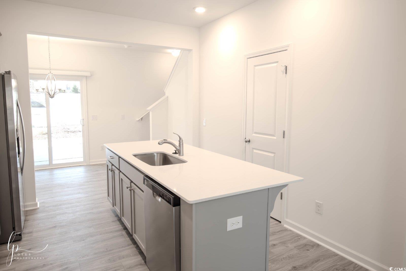 172 Crescent Way Little River, SC 29566 - Photo 5 of 18 Kitchen with stainless steel appliances, a sink, gray cabinetry, a chandelier, and light wood-style flooring
