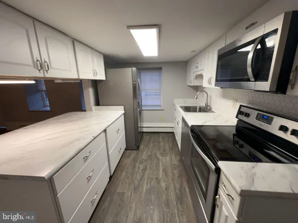a kitchen that has a sink and a stove in it