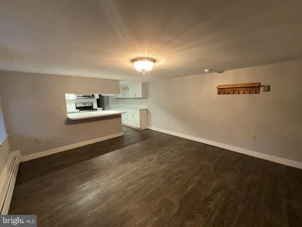a kitchen with a refrigerator and white cabinets