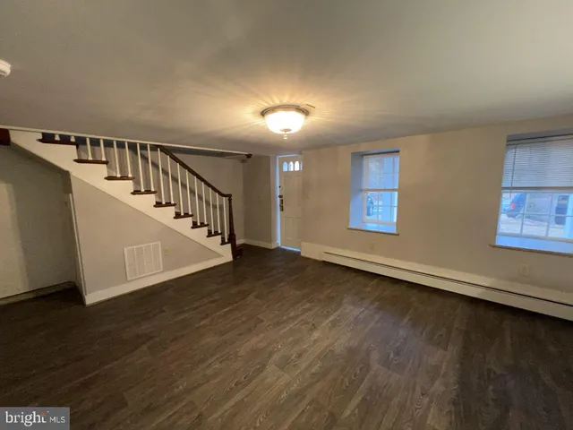 a view of an entryway with wooden floor