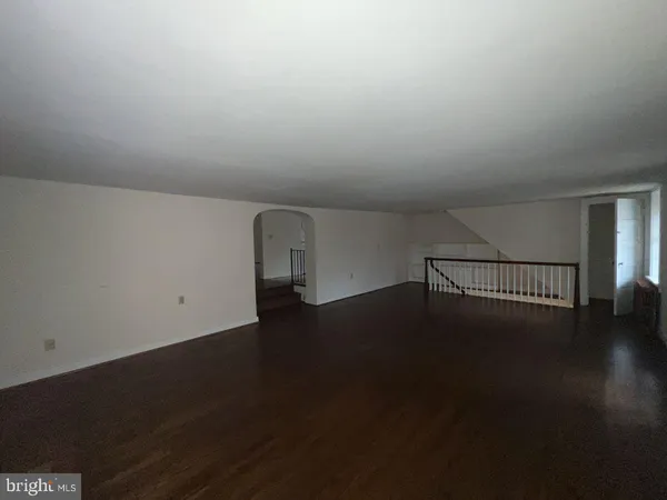 a view of a room with wooden floor and windows