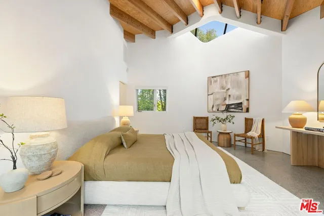 a bedroom with a bed and chair