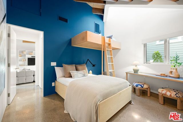 a living room with couches a fireplace and a dining table with a large window