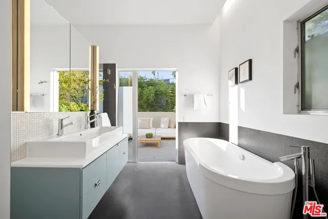 a kitchen with stainless steel appliances a sink stove and cabinets
