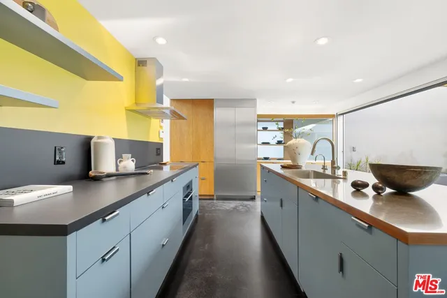 a living room with furniture a chandelier and a potted plant