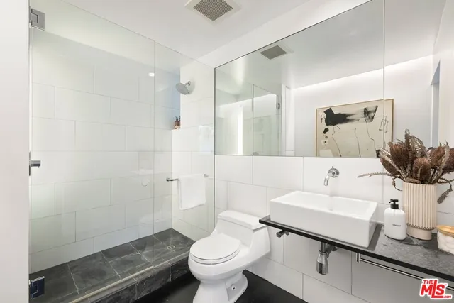 a view of a patio with couches table and chairs and potted plants