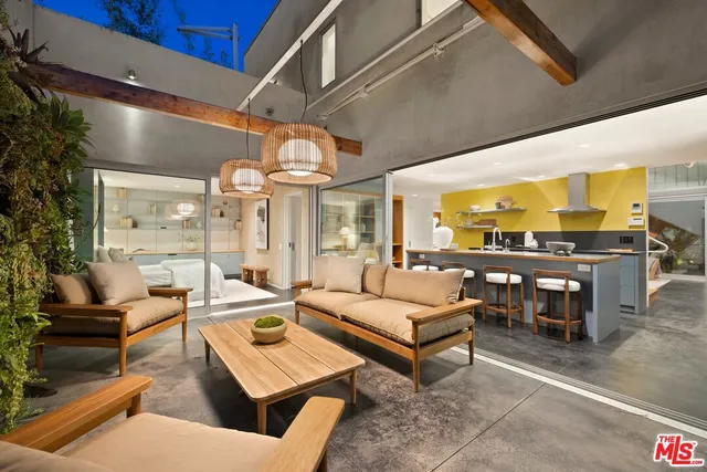 a living room with furniture a lamp and a large window