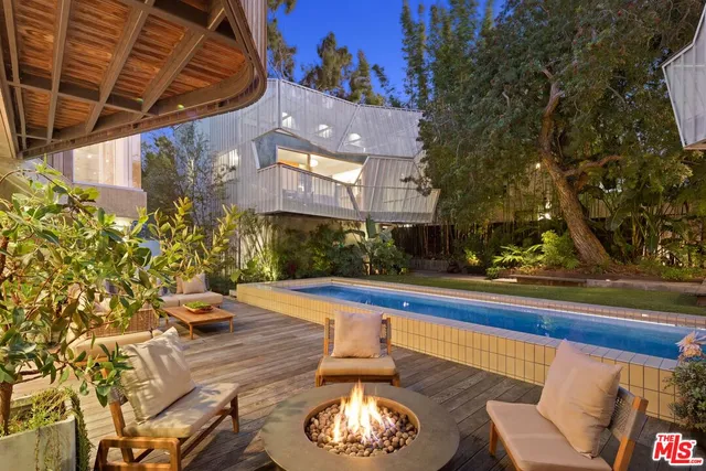 a view of a house with swimming pool and sitting area