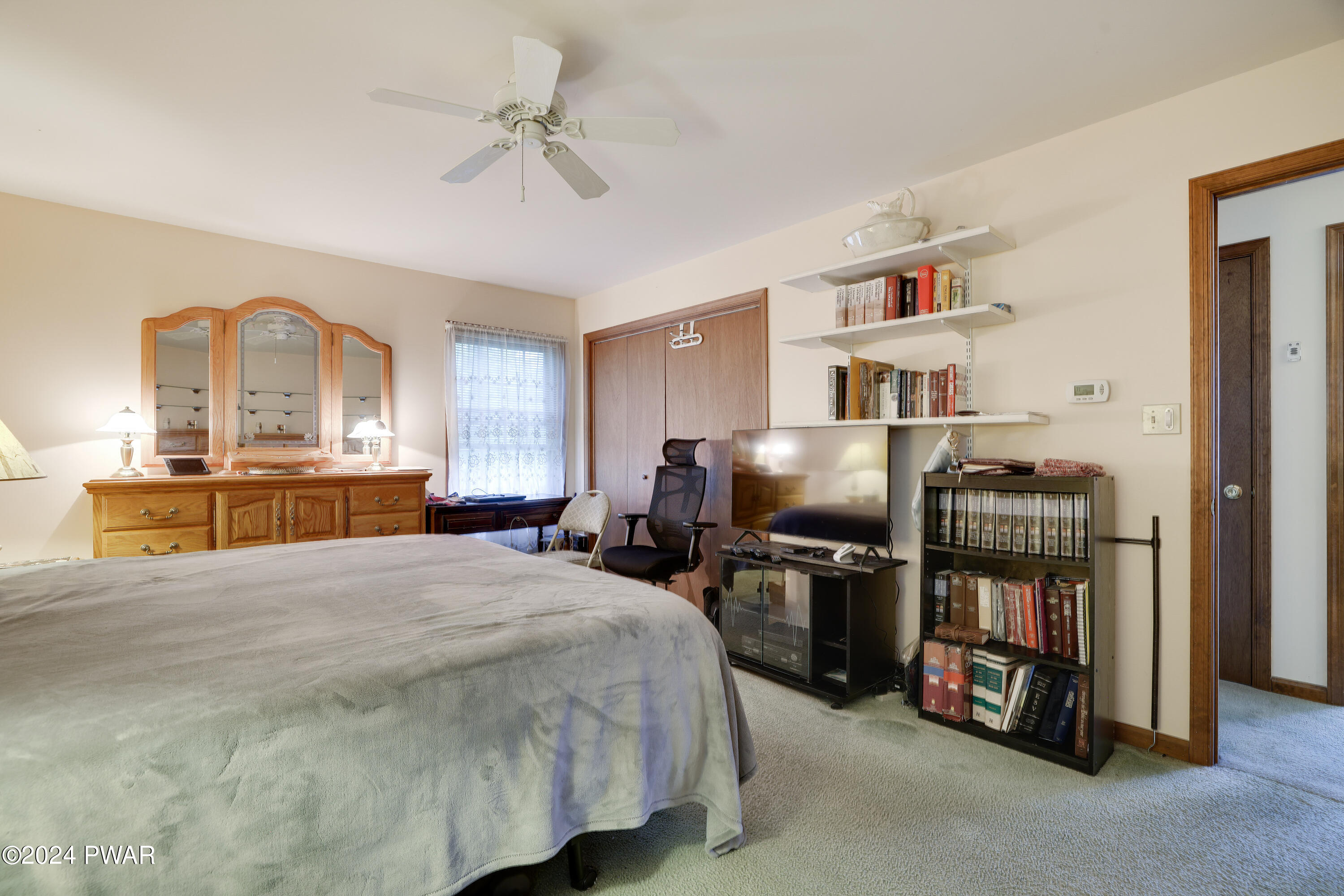 134 Magic Mountain Road Henryville, PA 18332 - Photo 39 of 62 a bedroom with a bed cabinets and a chandelier