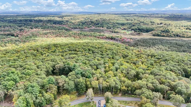 a view of a field with an ocean and mountain view