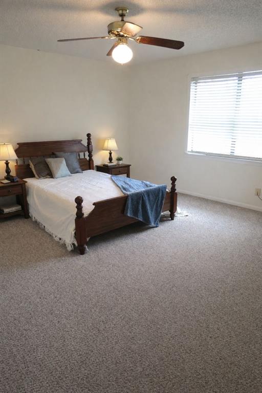543 County Road 2940 Alba, TX 75410 - Photo 11 of 15 a bed room with a bed and a chandelier
